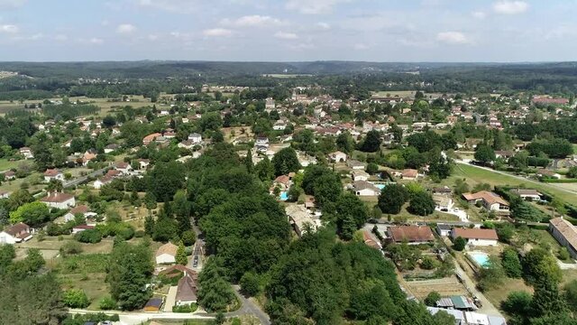 Aerial view of typical French landscape located in center of France real estate below in rural area beautiful summer day showing vacation houses and crips blue sky in background 4k high resolution