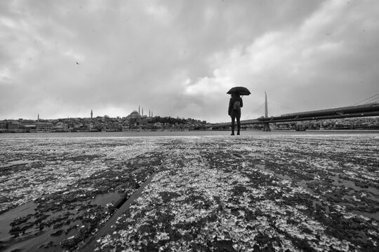 Woman standing by the golden horn coast in winter