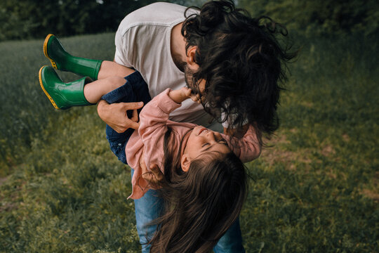 Father Playing With Daughter Outdoors