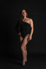 Fototapeta na wymiar fitness woman gym black. In a black bathing suit. Smiling shin, women healthy lifestyle. , torso. Worth a beautiful