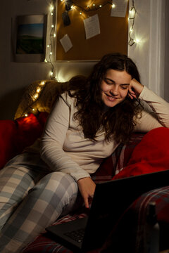 Happy girl shopping for Christmas online while staying at home.