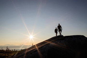 Two hikers walk above tree line on Moxie Bald Mountain in Maine.