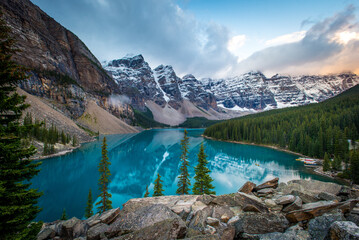 Canoers paddle a canoe at Sunrise on Moraine Lake in Banff National Park