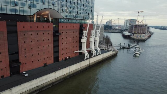 Building with a ship in the foreground 4k cinematic drone shot