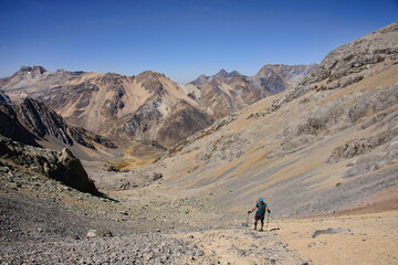 Fototapeta na wymiar Trekker heading to Santa Rosa Pass towards Sarapo Glacier on the Cordillera Huayhuash circuit, Ancash, Peru