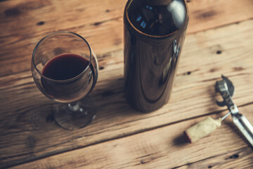 wine bottle and glass with opener