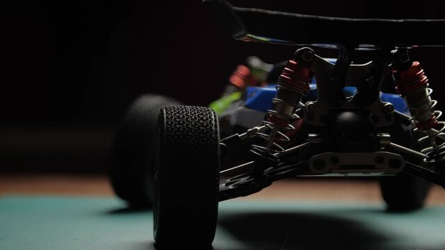 Close-up radio control model buggy car on cutting mat, rear view