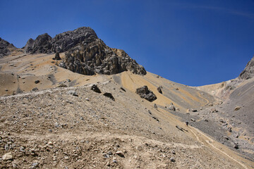 Trekker descending from Santa Rosa Pass towards Sarapo Glacier on the Cordillera Huayhuash circuit, Ancash, Peru