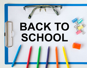 A clipboard with text Back To School eyeglasses paper clips