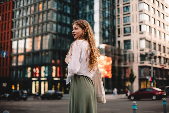 Portrait of thoughtful young woman standing on street in city