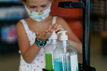 Girl hand sanitizer applying liquid gel sanitizer rubbing hands