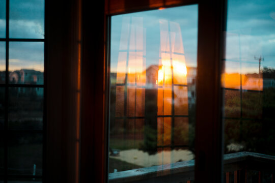 Sunrise reflected on the windows of a beach home
