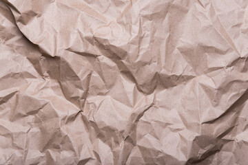 Fototapeta na wymiar crumpled cream craft paper background texture