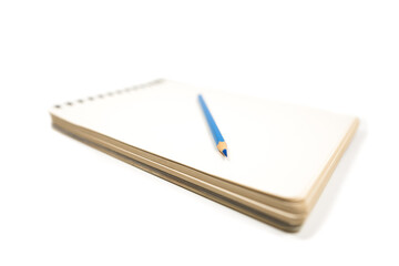 notebook and light blue pencil