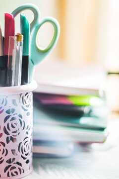 boat with pens and scissors on a table close-up