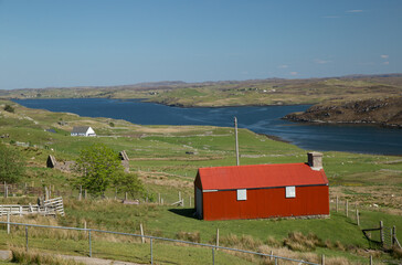 Red shed in front of Loch Eirasort on Isle of Harris, Scotland