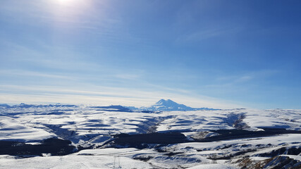 Obraz na płótnie Canvas Panorama of Elbrus, panorama of mountains, mountain peaks, snow. Mount Elbrus in winter.