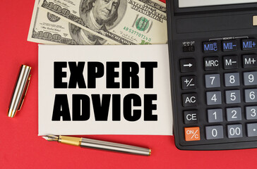 On a red background, among the money, a calculator and a pen lies a sign with the text - EXPERT ADVICE