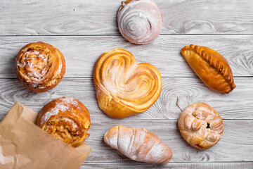 Fototapeta premium delicious sweet browned cakes bakery products on wooden table.