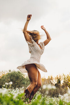 Woman Dancing In Nature With Hair On Her Face