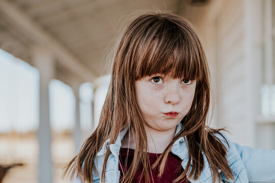 silly young girl with red hair making a goofy face