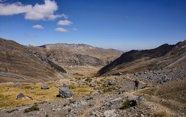 Fototapeta na wymiar A trekker with the epic views along Jahuacocha on the Cordillera Huayhuash circuit, Ancash, Peru
