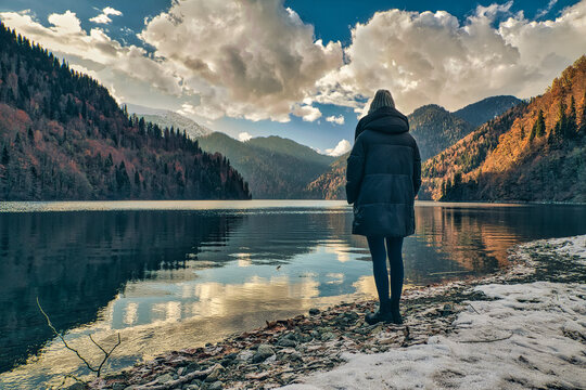 Woman standing on lakeside in morning time