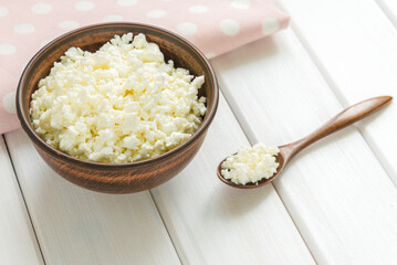 Cottage cheese with apples for breakfast in a bowl close up. pink polka dot napkin. Top view image. Copyspace for your text
