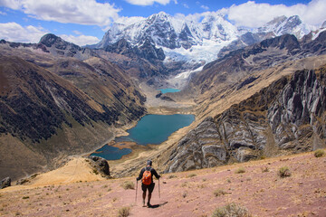 A trekker descending down to Laguna Jahuacocha and the entire Cordillera Huayhuash, Ancash, Peru.