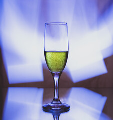 glass glass with champagne on a multicolored background