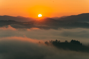 Scenic view of a panorama of a mountain slope with a fog and a haze in Ukraine, Carpathians.