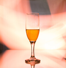 glass glass with champagne on a multicolored background