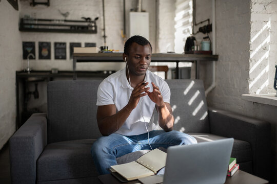 Black student talking with teacher online