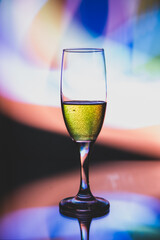 glass glass with champagne on a multicolored background
