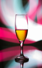 glass glass with champagne on a multicolored background