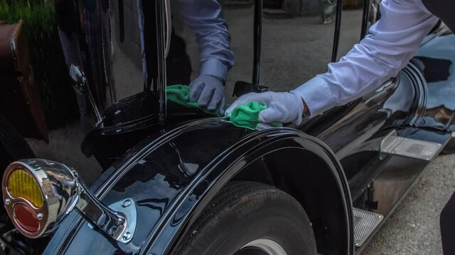 Chauffeur Gently Polishing Wheel Arch Of Vintage Car. Slow Motion