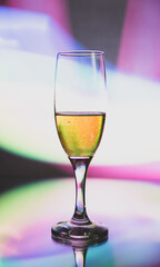 glass glass with champagne on a multicolored background