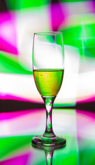 glass glass with champagne on a multicolored background