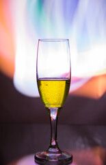 glass glass with champagne on a multicolored background