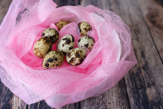 Eggs For The Easter Holiday In A Pink Basket On A Wooden Table Side View