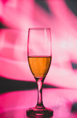 glass glass with champagne on a multicolored background