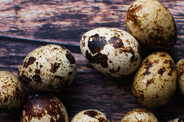 Obraz premium quail eggs on a wooden table macro photography