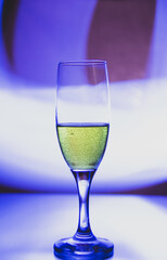 glass glass with champagne on a multicolored background
