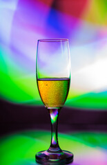 glass glass with champagne on a multicolored background
