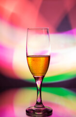 glass glass with champagne on a multicolored background