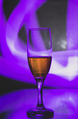 glass glass with champagne on a multicolored background