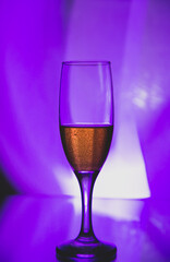 glass glass with champagne on a multicolored background