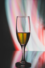 glass glass with champagne on a multicolored background