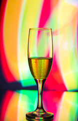 glass glass with champagne on a multicolored background