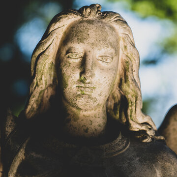 Close up an angel. Retro styled image of an ancient stone statue.